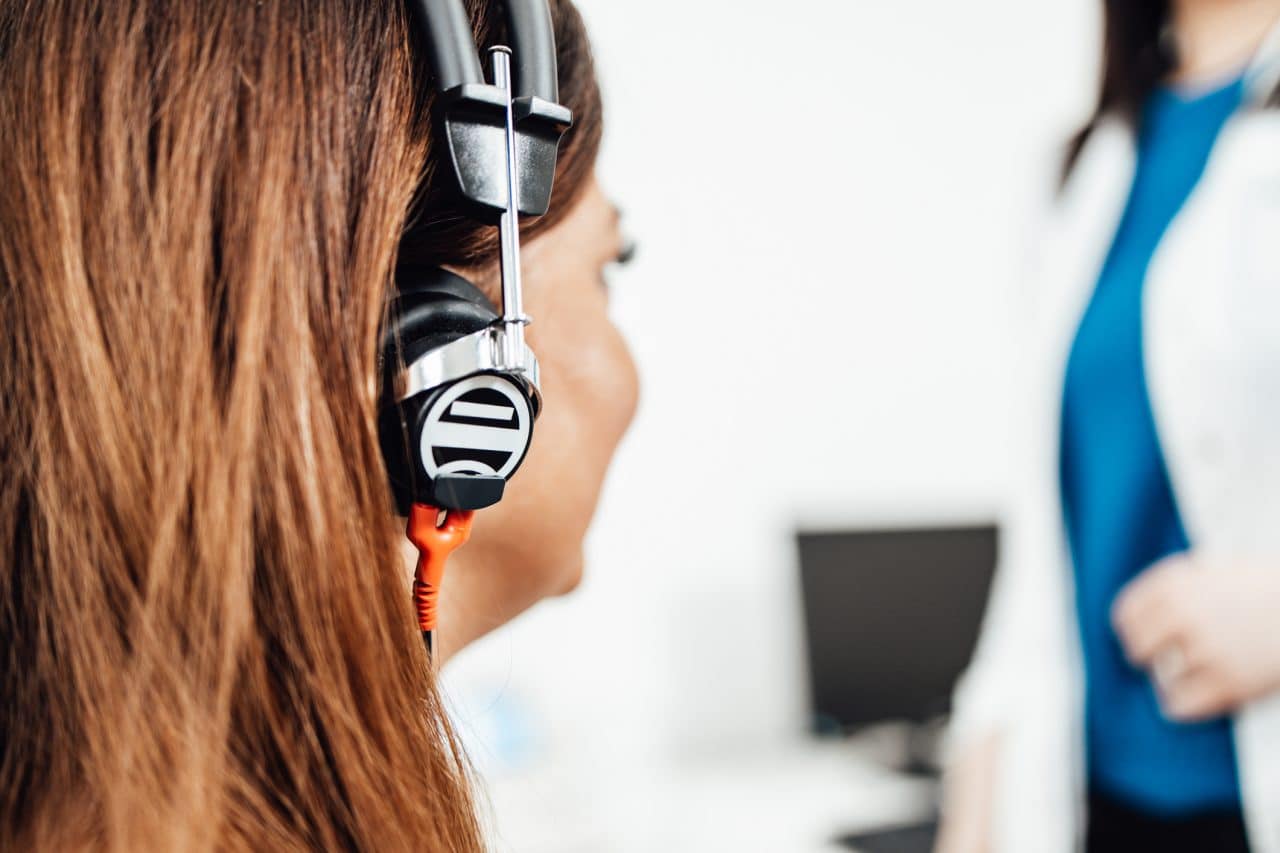Woman with headphones taking a hearing test.